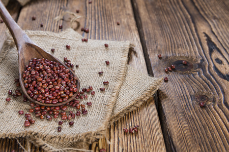 Heap of dried Red Beans (close-up shot) on wooden backgroundの写真素材