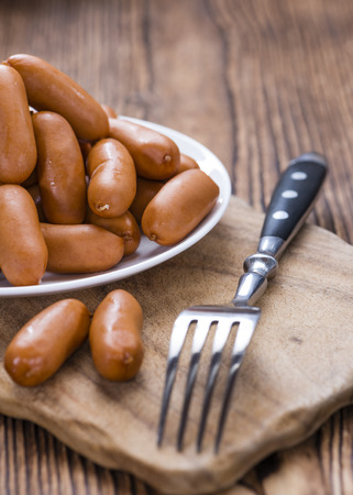 Small Sausages on an old rustic wooden backgroundの写真素材