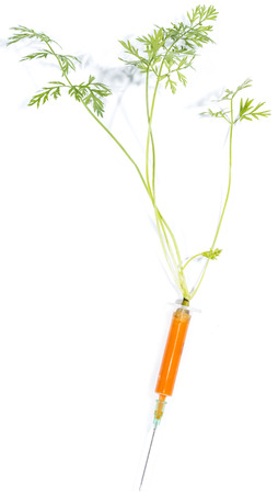 Carrot Injection (with green) isolated on white backgroundの写真素材