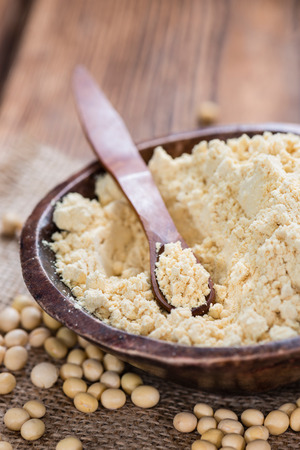 Portion of Soy Flour on dark rustic wooden backgroundの写真素材