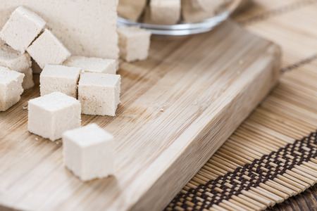 Portion of Tofu (detailed close-up shot) on wooden backgroundの写真素材