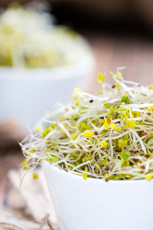 Fresh Broccoli Sprouts (detailed close-up shot) on vintage wooden backgroundの写真素材