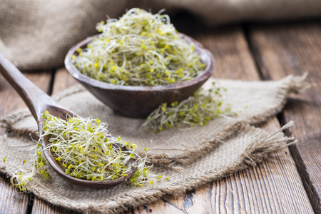 Some fresh Broccoli Sprouts (close-up shot) on rustic wooden backgroundの写真素材