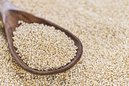Portion of Quinoa (close-up shot) on a wooden spoon)の写真素材