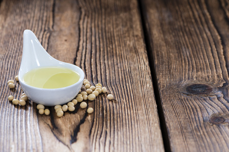 Portion of Soy Oil (close-up shot) on an old wooden tableの写真素材