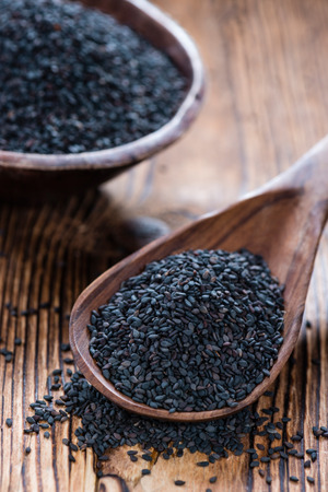 Small portion of black Sesame (close-up shot) on wooden backgroundの写真素材