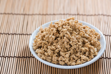 Portion of Soy Meat close-up shot (on wooden background)