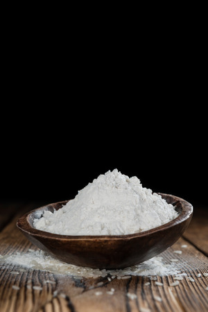 Heap of Rice Flour(close-up shot) on wooden backgroundの写真素材