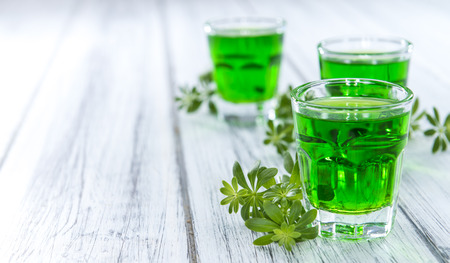 Sweet Woodruff Liqueur in a small glass (close-up shot)