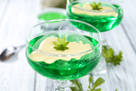Woodruff Jelly with Vanilla Sauce on wooden backgroundの写真素材