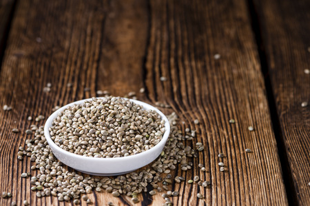 Hemp Seeds (close-up shot) on an old wooden tableの写真素材