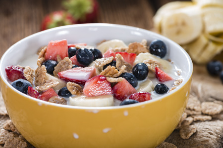 Healthy Breakfast (Cornflakes with Fruits) on a wooden table