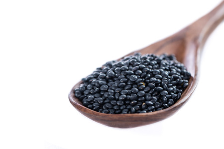 Portion of Black Lentils (detailed close-up shot) isolated on white backgroundの写真素材
