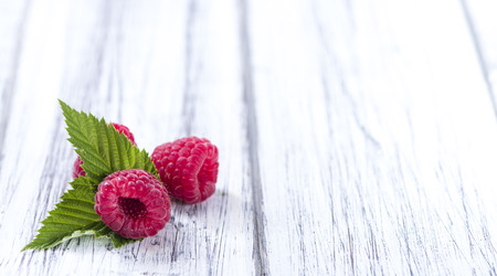 Portion of fresh Raspberries on wooden background