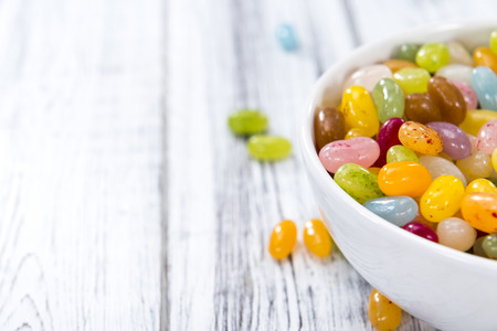 Heap of colorfull Jelly Beans (on bright wooden background)の写真素材