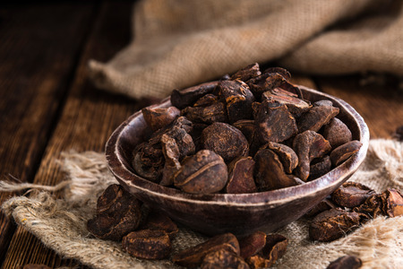 Whole dried Cola Nuts (close-up shot) on wooden backgroundの写真素材
