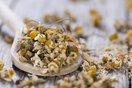 Dried Camomile (close-up shot) on rustic wooden backgroundの写真素材