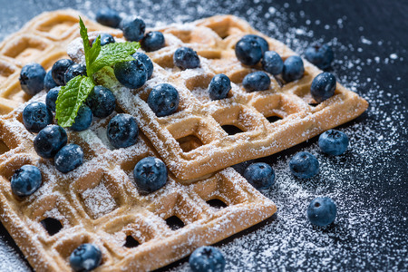 Homemade Waffles with Blueberries and powder sugar (close-up shot)の写真素材