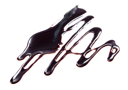 Chocolate Sauce isolated on wooden background (close-up shot)の写真素材