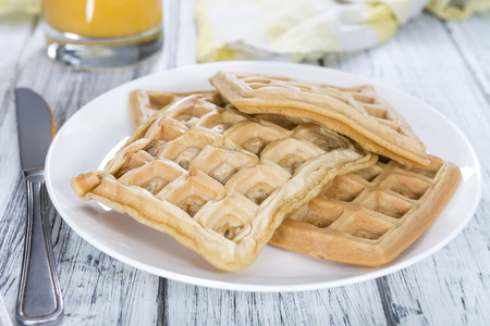 Portion of fresh made Waffles (detailed close-up shot) on wooden backgroundの写真素材