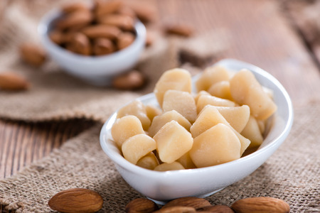 Portion of Marzipan (close-up shot) on wooden backgroundの写真素材