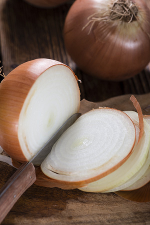 Portion of fresh Onions (white) on wooden backgroundの写真素材
