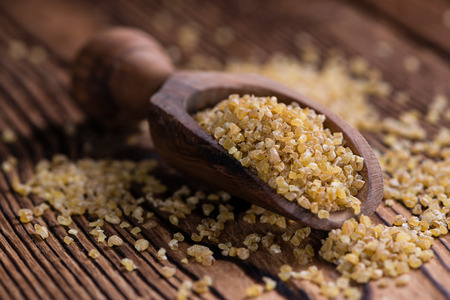 Raw Bulgur (on wooden background) as detailed close-up shotの写真素材