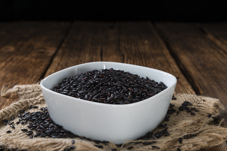 Portion of Black Rice (close-up shot) on wooden backgroundの写真素材