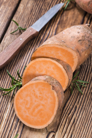 Sweet Potato (close-up shot) on rustic wooden backgroundの写真素材