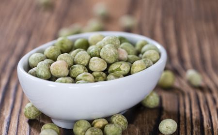 Heap of dried green Peas (close-up shot) on wooden backgroundの写真素材