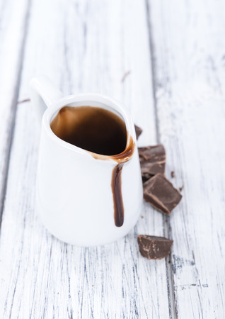 Dessert Sauce (dark Chocolate) on an old rustic wooden tableの写真素材