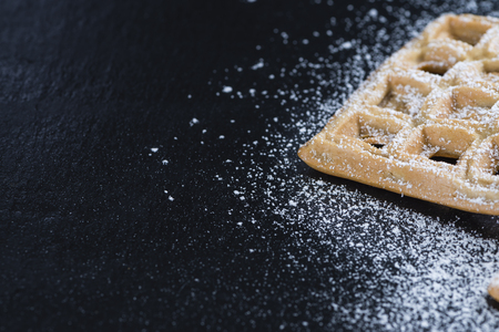 Fresh made Waffles with powder sugar (close-up shot)の写真素材