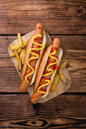 Homemade Hot Dog with ketchup and mustard on rustic wooden backgroundの写真素材