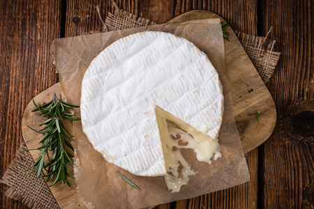 Camembert (close-up shot) on an old rustic wooden table