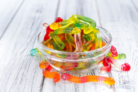 Portion of Gummi Candy (close-up shot) on wooden background