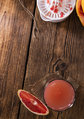 Fresh Grapefruit Juice on rustic wooden background (close-up shot)の写真素材