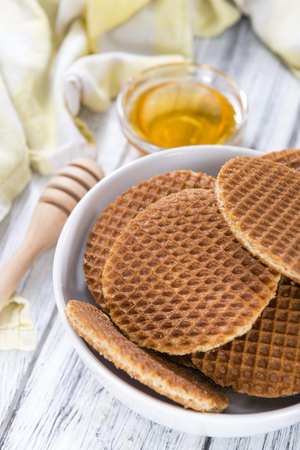 Crunchy homemade Waffles filled with golden honey (on wooden background)の写真素材