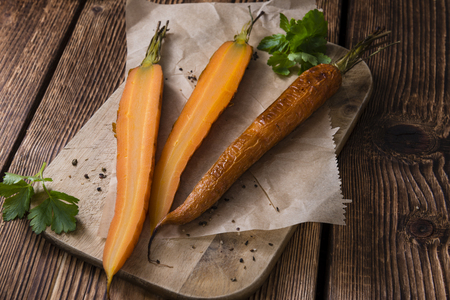 Portion of Baked Carrots (close-up shot)on an old vintage backgroundの写真素材