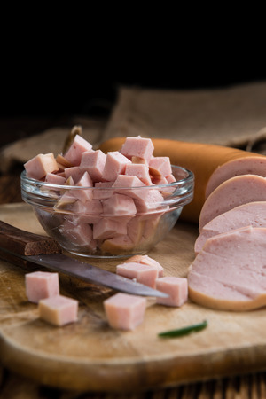 Sliced Baloney (close-up shot) on dark wooden backgroundの写真素材