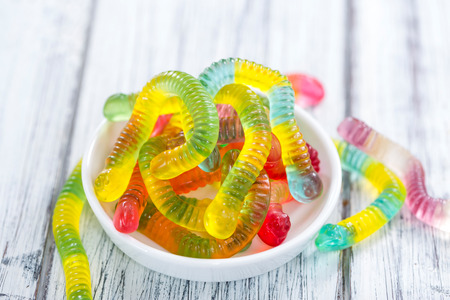 Portion of Gummi Candy (close-up shot) on wooden backgroundの写真素材