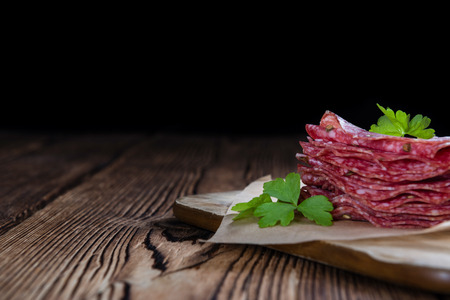 Smoked Salami (selective focus) on an old vintage wooden tableの写真素材