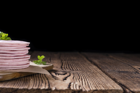 Old rustic wooden table with Ham Sausage (selective focus)の写真素材