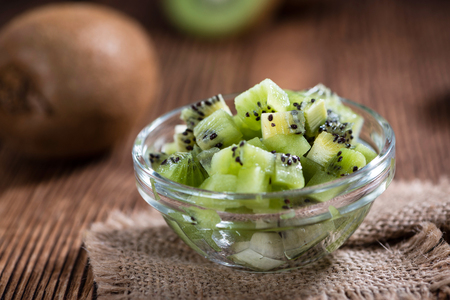 Portion of fresh Kiwi Fruits (selective focus) on wooden backgroundの写真素材
