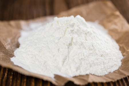 Portion of Milk Powder (selective focus) on an old wooden tableの写真素材