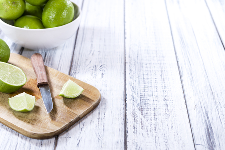Some fresh Limes (selective focus) on an old wooden table (close-up shot)の写真素材