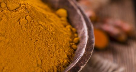 Portion of Turmeric (selective focus) on an old wooden tableの写真素材