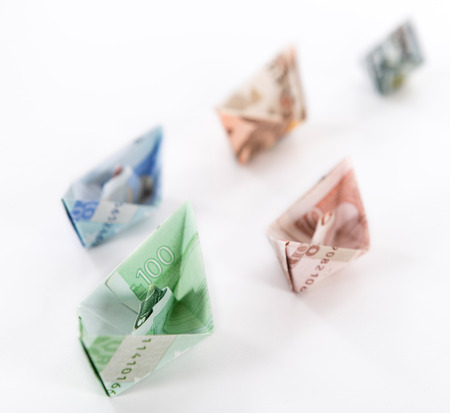 Boats made out of European banknotes on white background (close-up shot)の写真素材