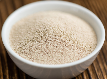 Portion of dried Yeast (close-up shot) on wooden backgroundの写真素材