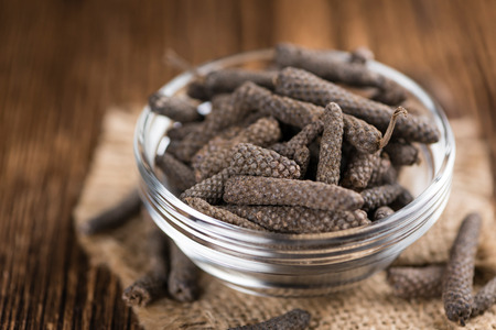 Long Pepper (dried) on an old wooden table (selective focus)の写真素材