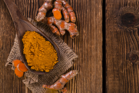 Portion of Turmeric (selective focus) on an old wooden tableの写真素材
